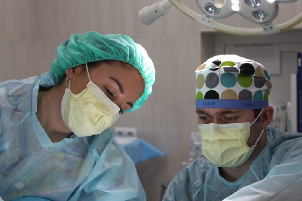 Two surgeons examining something